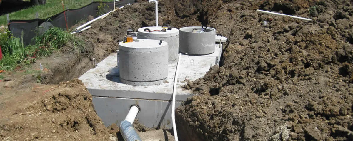 Septic system repair and installation site with tank access ports in Bloomington, IN