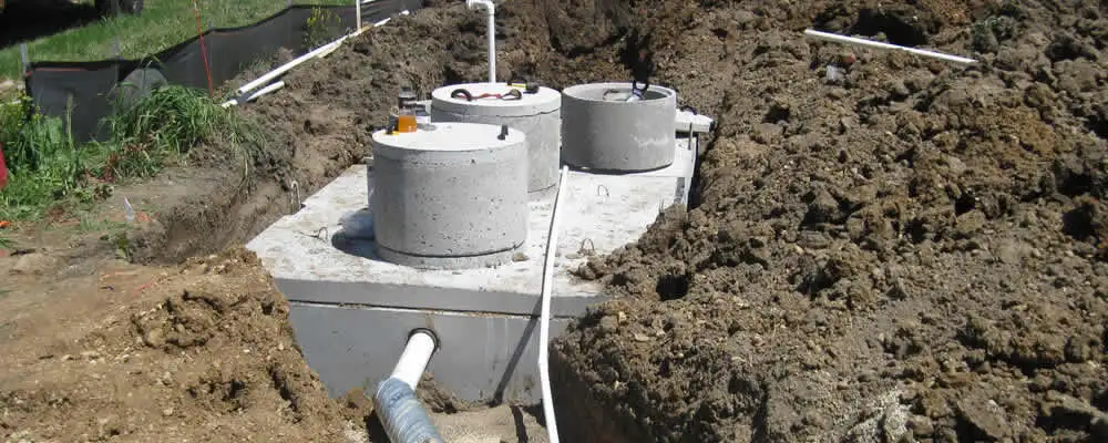 Septic system repair and installation site with tank access ports in Bloomington, IN