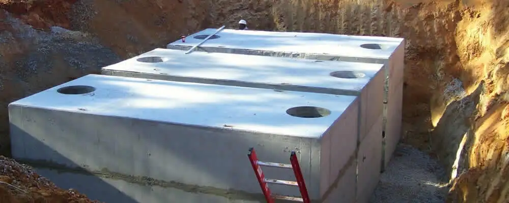 Septic tank installation site with a newly placed concrete tank in Bloomington, IN